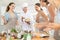 Elderly woman cook posing with prepared chicken dish