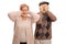 Elderly woman covering her ears and an elderly man covering his