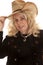 Elderly woman cowgirl hold hat close