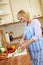 Elderly woman cutting kohlrabi