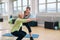 Elderly woman doing exercise with her personal trainer