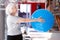 Elderly woman doing exercises with fitness ball