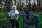 Elderly woman is doing exercises on the sport playground. Sport.