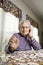 Elderly Woman Doing Jig Saw Puzzle