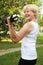 Elderly woman doing outdoor training with dumbbell