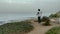 Elderly woman doing physical exercises on a high seashore