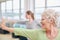 Elderly woman doing stretching workout at yoga class