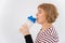 Elderly woman drinks water while exercising on white background.