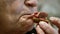 An elderly woman is eating a sandwich with gray bread. old woman chewing, close-up