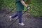 elderly woman is engaged in Nordic walking with sticks in the spring forest