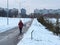 An elderly woman is engaged in Nordic walking in the winter. The health benefits of walking for older people with sticks