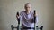 An elderly woman is engaged in a sports simulator at home