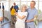 Elderly woman enjoying merengue with male partner in latin dance class