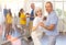 Elderly woman enjoying merengue with male partner in latin dance class