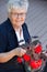 Elderly woman with flower pot