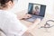 An elderly woman with the flu for an online consultation with a doctor. Female practitioner makes a video call with a