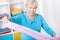 Elderly woman during folding laundry