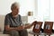 Elderly woman with framed photos