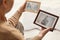 Elderly woman with framed photos