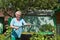 An elderly woman in the garden with water