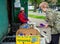 An elderly woman gives recyclable materials at a reception point, the city of Voronezh