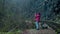 Elderly woman in glasses walks photographs