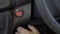 Elderly woman hand push start car engine button