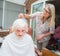 Elderly woman has hair cut by her carer during Corona virus lockdown at home