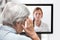 Elderly Woman with headache, Doctor on the monitor listening, co