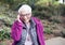 Elderly Woman in her Eighties on Mobile Phone in Park