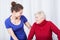 Elderly woman and her smiling granddaughter