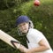 Elderly woman hitting cricket ball