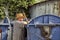 Elderly woman hoarder rummaging in a dumpster