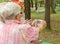 Elderly woman is holding a monitor measuring body fat and looking at measurements