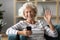 Elderly woman holding smartphone wave hand having videocall