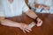 Elderly woman holds pills and ampoule. Close-up of pensioner`s hands with drugs. Young woman unpacks the syringe