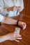 Elderly woman holds pills and ampoule. Close-up of pensioner`s hands with drugs. Young woman unpacks the syringe