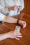 Elderly woman holds pills and ampoule. Close-up of pensioner`s hands with drugs. Young woman unpacks the syringe. Daughter is