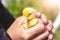 An elderly woman holds a small duckling in her hands. Love for animals