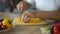 Elderly woman hugging husband, cooking healthy breakfast, fresh vegetables