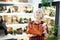 Elderly woman inspects shop window and is looking for modern, fashionable and roomy handbag