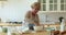 Elderly woman knead dough for pastries cooking in modern kitchen