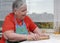 Elderly woman kneading dough