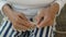 An elderly woman knits on knitting needles, portrait and close-up.