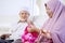 Elderly woman knitting while her husband watching