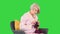 Elderly woman knitting sitting on a chair on a Green Screen, Chroma Key.