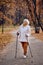 elderly woman lead healthy lifestyle, nordic walking in park.Senior active caucasian woman looks happy