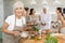 Elderly woman learns to cook at master class