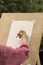 An elderly woman learns to draw in an art studio