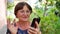 Elderly woman listen music by red headphones